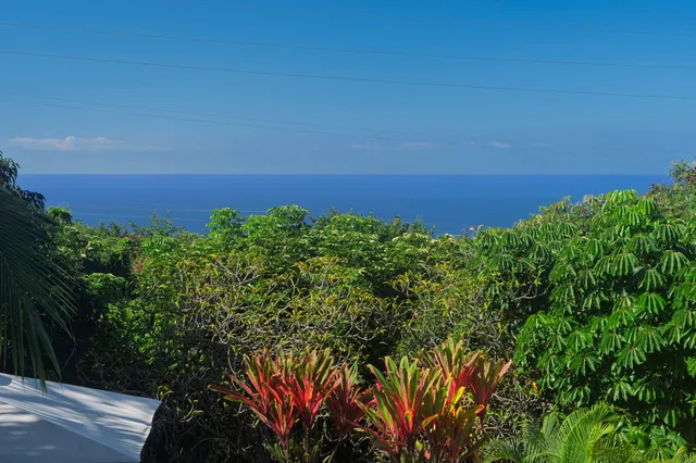 a balcony with wooden floor outdoor seating and yard in the back