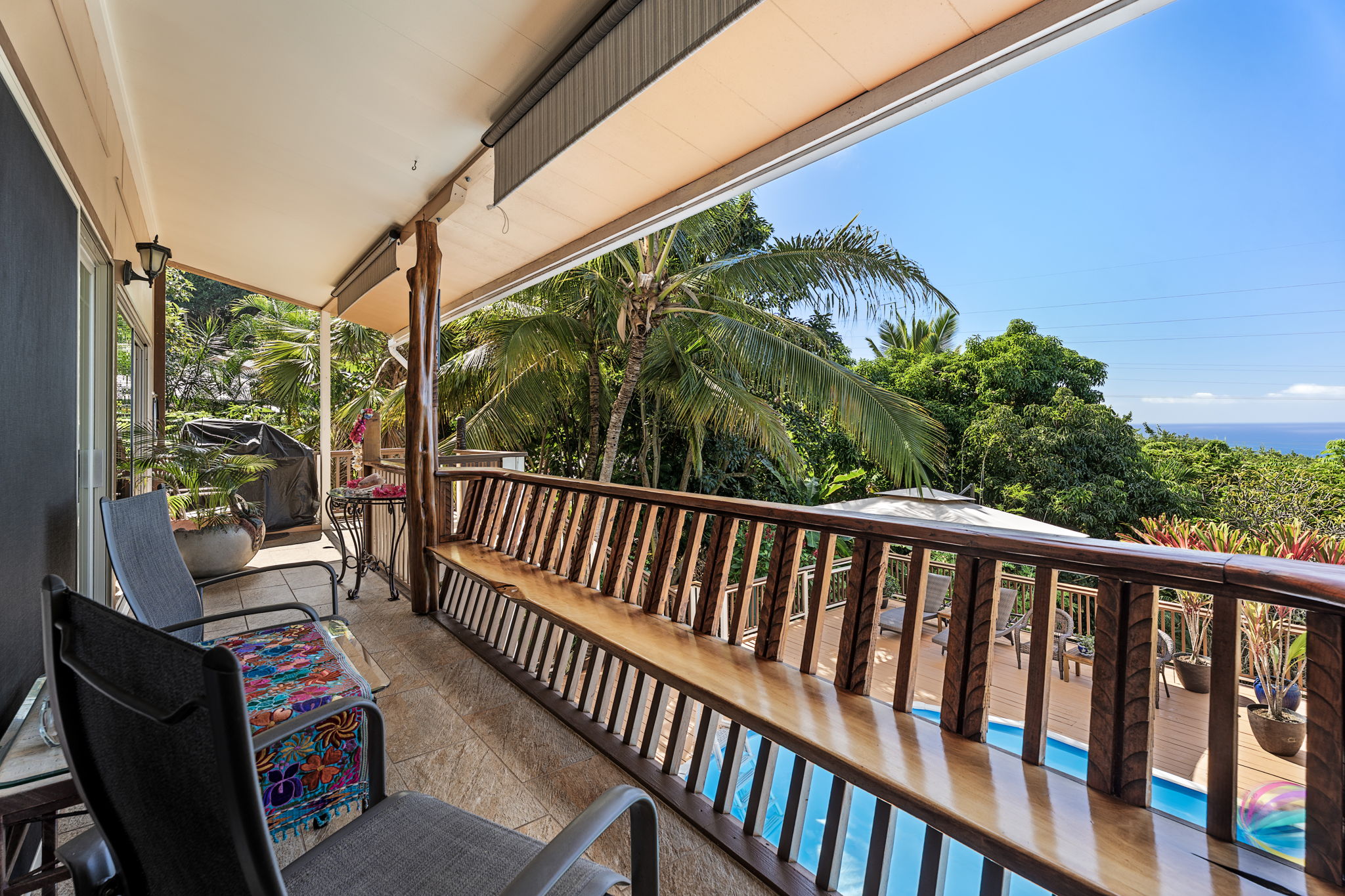 78-6960-a Walua Road Kailua-Kona, HI 96740 - Photo 3 of 29 a balcony with wooden floor outdoor seating and yard in the back