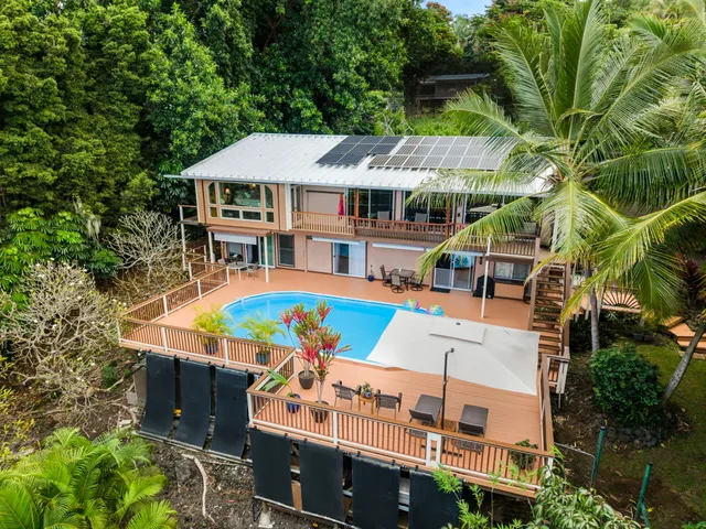 an aerial view of a house with a yard