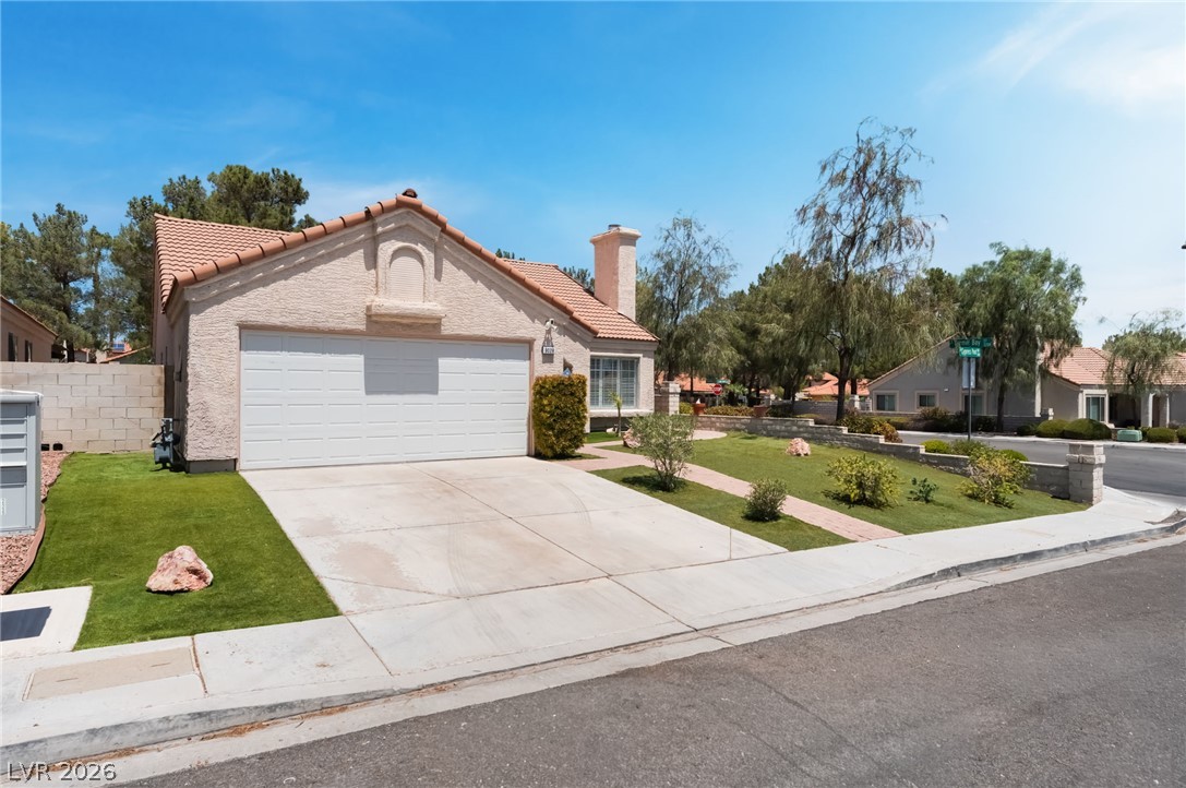 9028 Cypress Point Road Las Vegas, NV 89117 - Photo 5 of 39 A well-maintained suburban home featuring a concrete driveway and neatly landscaped front yard.
