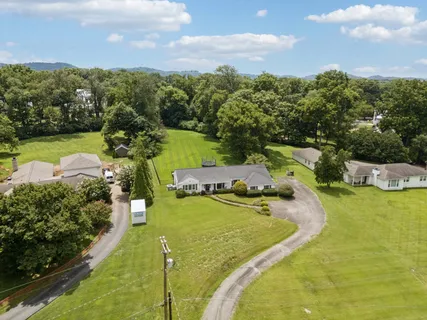 a view of a swimming pool with a yard