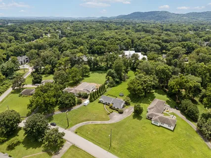 an aerial view of a residential houses with outdoor space