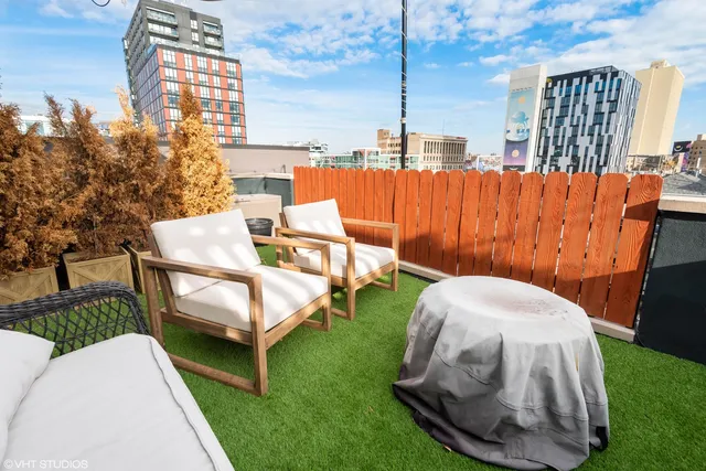a view of a chairs and table in backyard