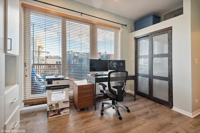 a view of a workspace with furniture and a window