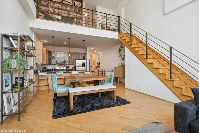 a living room with stainless steel appliances kitchen view and dining table