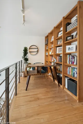 a view of a livingroom with furniture and a book shelf