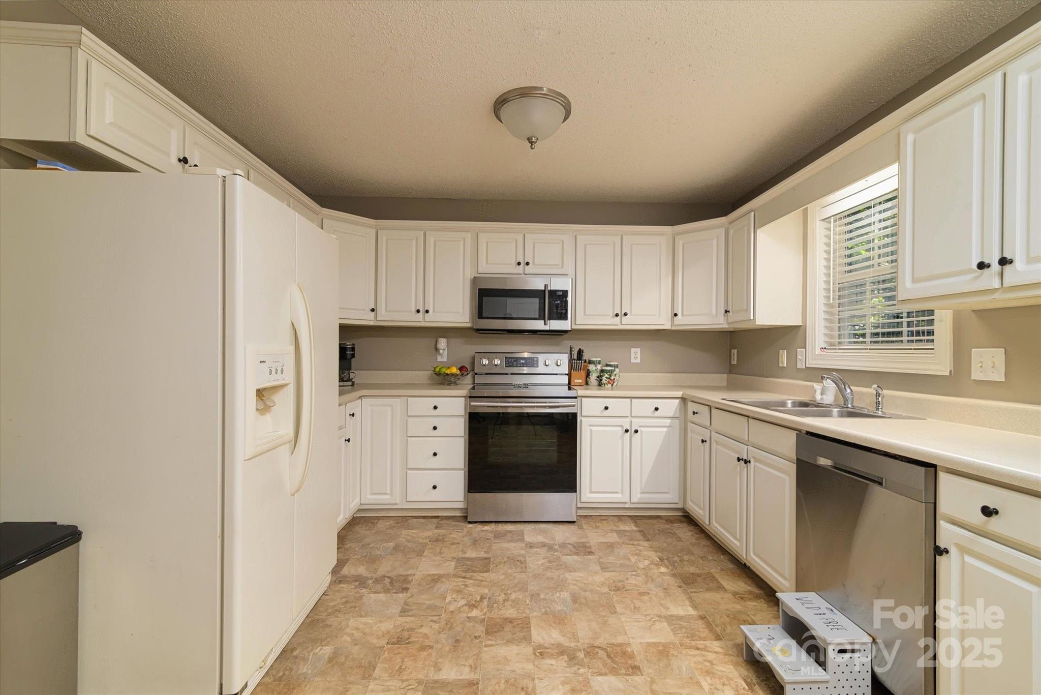 914 Ragin Lane Rock Hill, SC 29732 - Photo 17 of 31 a kitchen with granite countertop white cabinets and white appliances