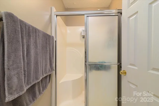 a bathroom with a glass shower door