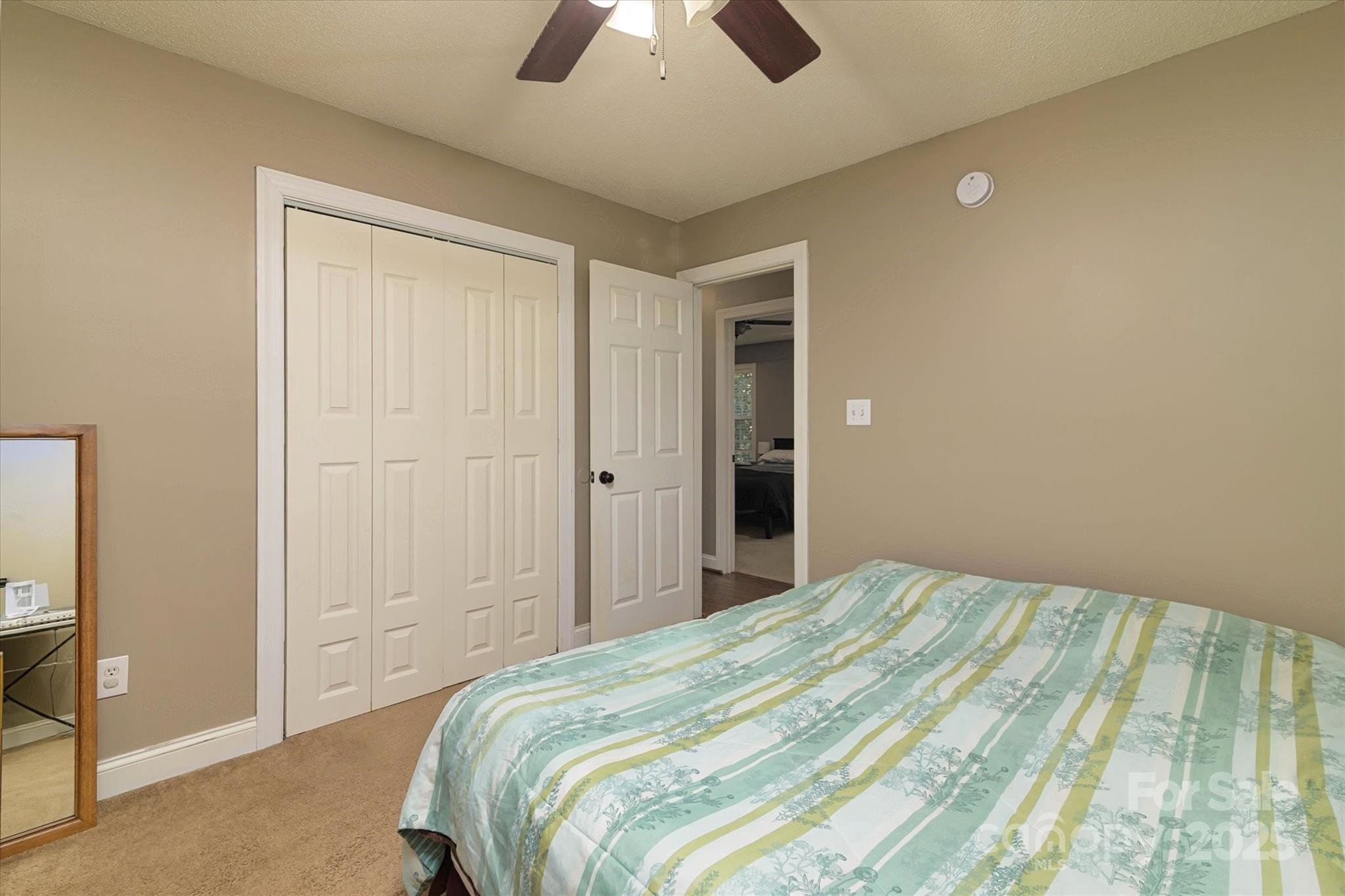 914 Ragin Lane Rock Hill, SC 29732 - Photo 30 of 31 a bedroom with a bed and a chandelier