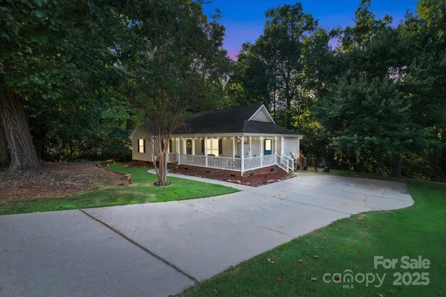 a view of backyard of house with green space