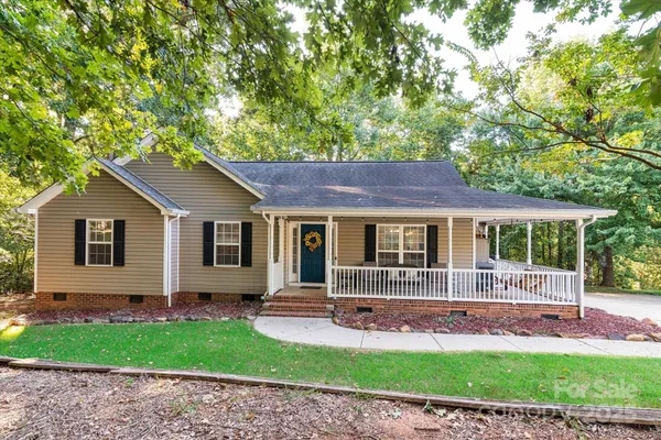 a front view of a house with a garden and yard