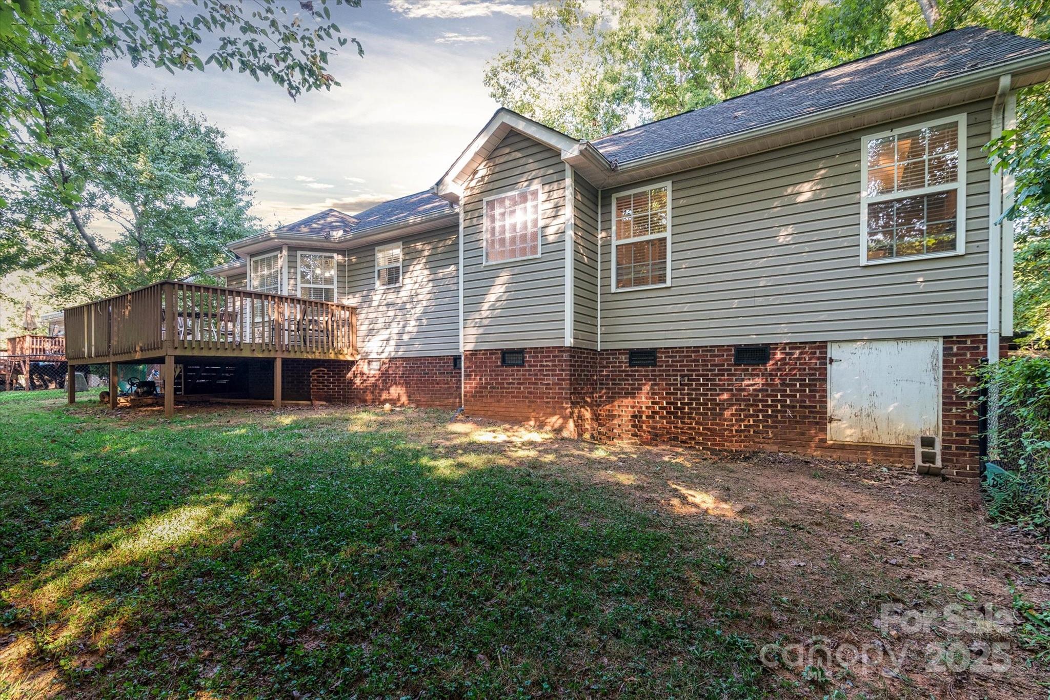 914 Ragin Lane Rock Hill, SC 29732 - Photo 8 of 31 a backyard of a house with wooden deck table and chairs