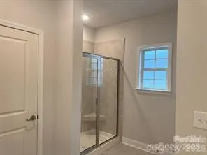 a bathroom with a glass shower door