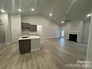 a large room with a kitchen and a sink