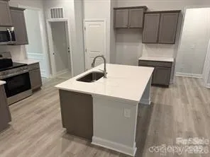 a kitchen with sink and refrigerator
