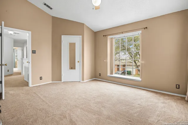 a bathroom with a toilet a sink a mirror and a shower