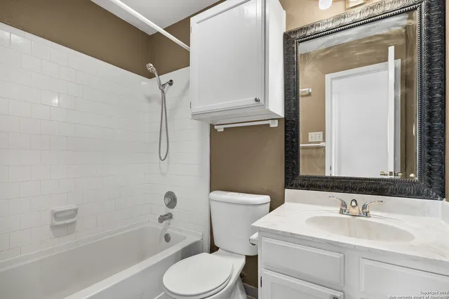 a view of a backyard with wooden fence