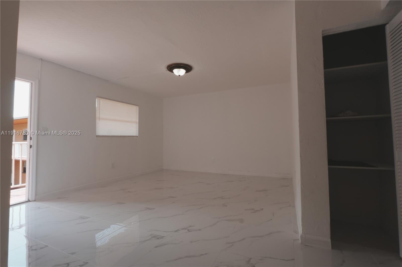 1245 West 24th Street, Unit 210 Hialeah, FL 33010 - Photo 15 of 22 an empty room with windows