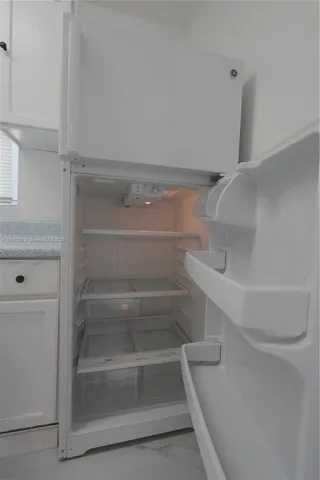a kitchen with cabinets and window