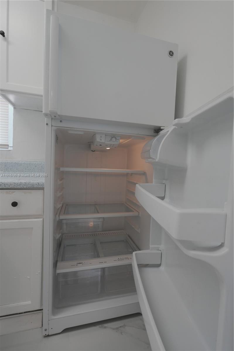 1245 West 24th Street, Unit 210 Hialeah, FL 33010 - Photo 18 of 22 a view of walk in closet with empty racks