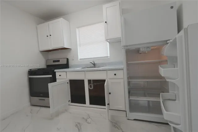 a view of a house with a tree in front