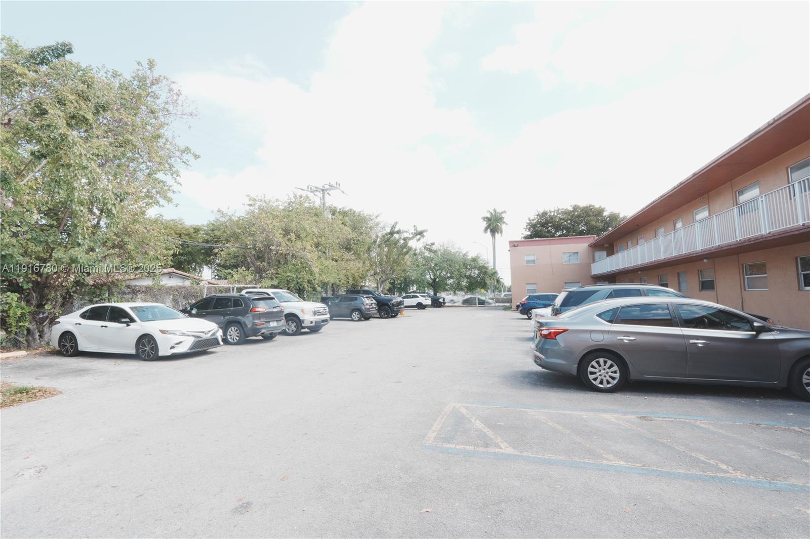 1245 West 24th Street, Unit 210 Hialeah, FL 33010 - Photo 2 of 22 a view of a cars parked in front of a house