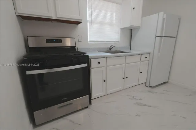 a kitchen with appliances and cabinets