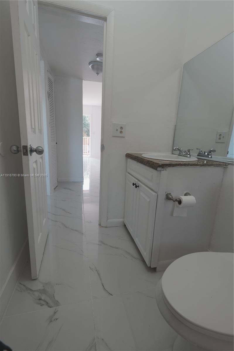 1245 West 24th Street, Unit 210 Hialeah, FL 33010 - Photo 10 of 22 a bathroom with a sink and toilet
