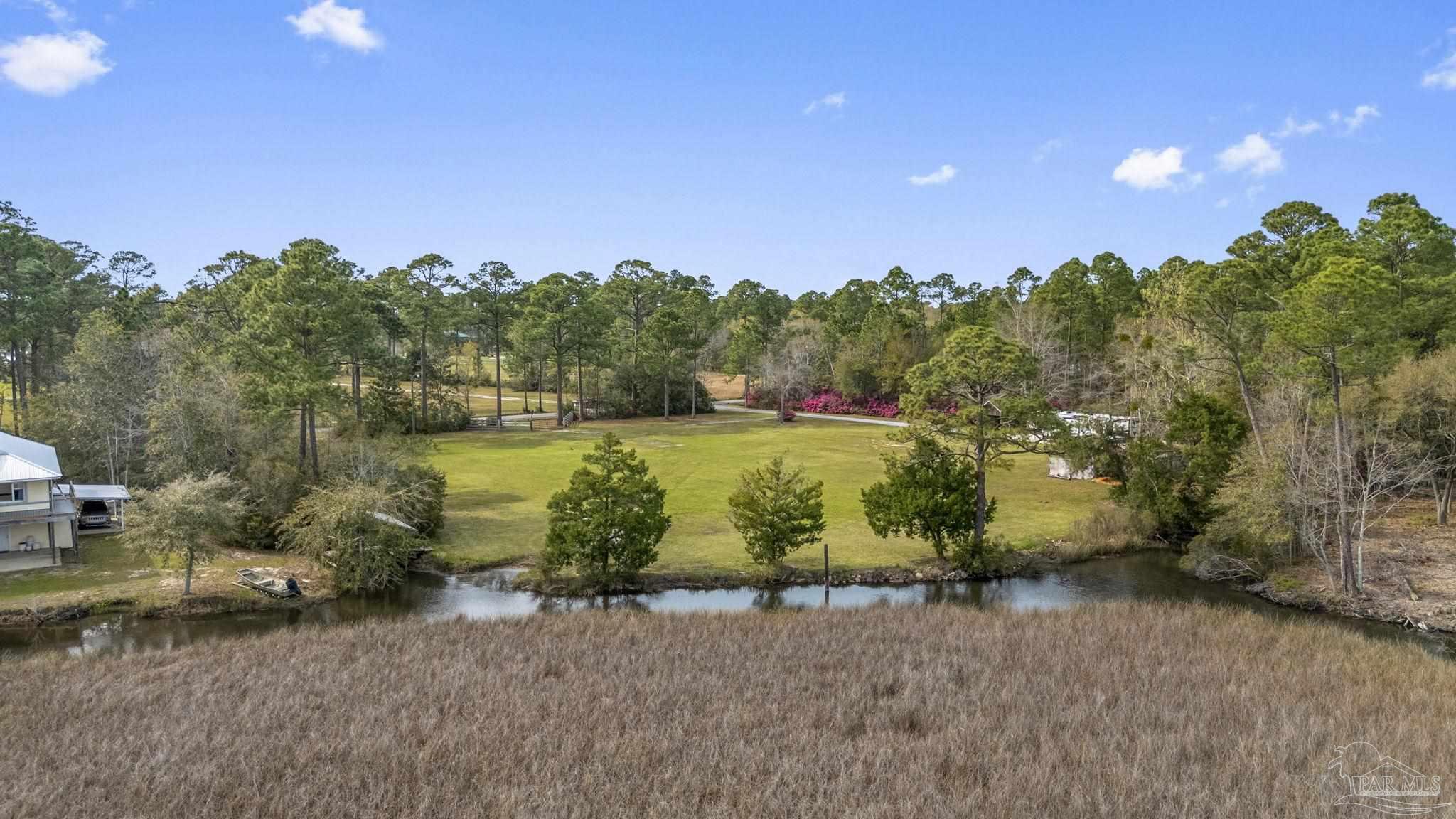 7524 Petersen Point Road Milton, FL 32583 - Photo 1 of 26 a view of a lake with a houses