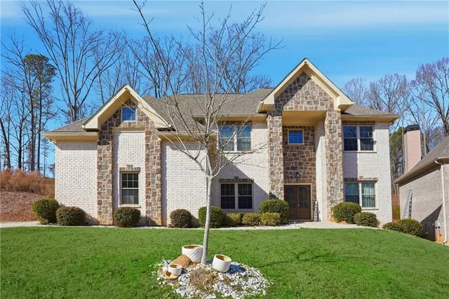 a view of a hallway with wooden floor and glass door