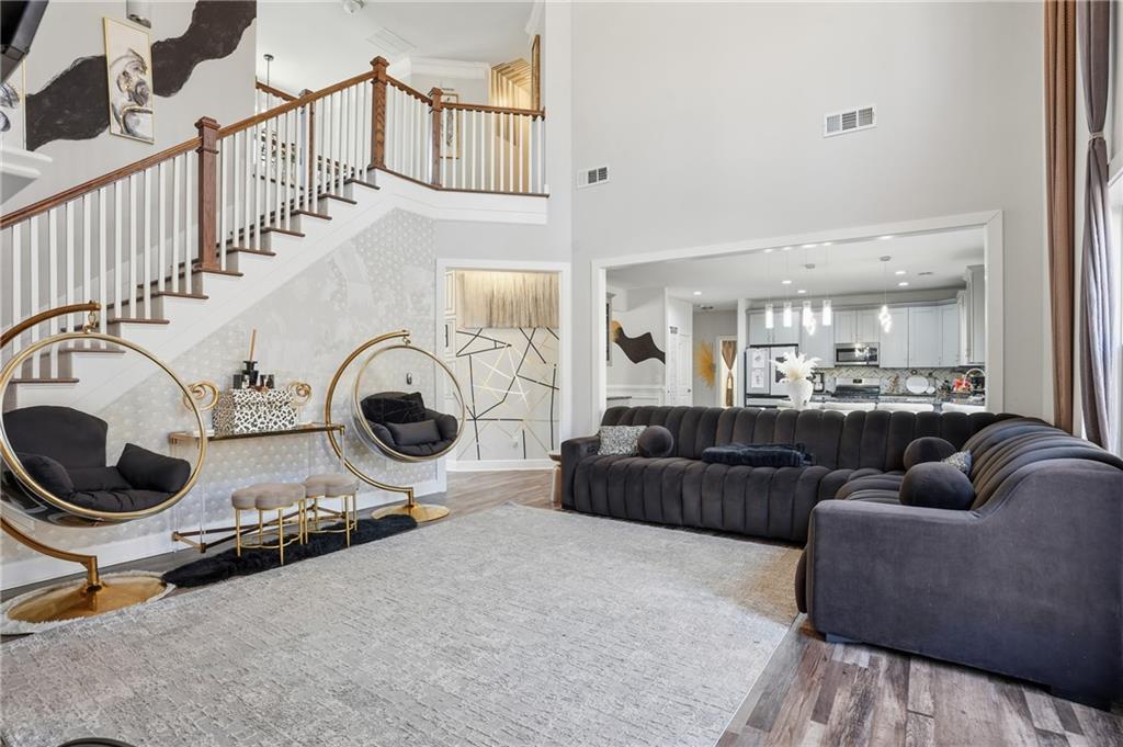 5663 Eternal Drive Atlanta, GA 30349 - Photo 13 of 37 a living room with furniture a flat screen tv and a view of kitchen