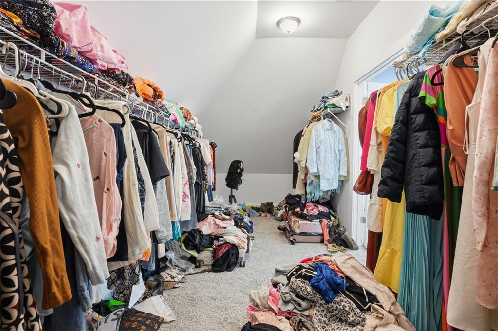 5663 Eternal Drive Atlanta, GA 30349 - Photo 20 of 37 a view of walk in closet with clothes and shoes