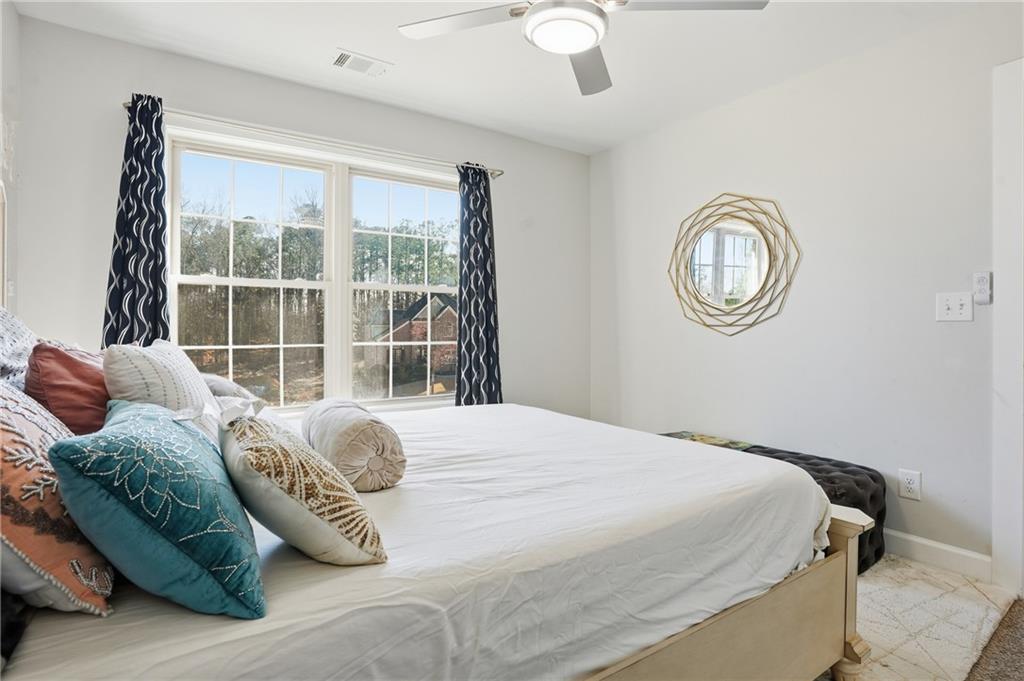 5663 Eternal Drive Atlanta, GA 30349 - Photo 24 of 37 a bedroom with a bed and a window