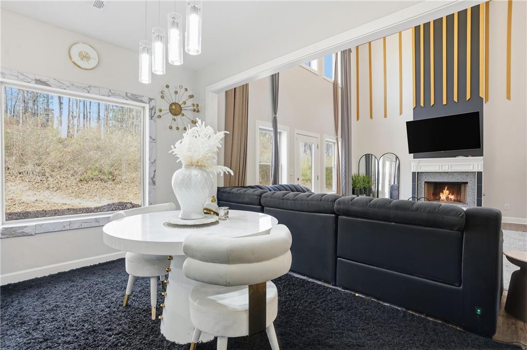 5663 Eternal Drive Atlanta, GA 30349 - Photo 10 of 37 a living room with furniture a flat screen tv and a large window