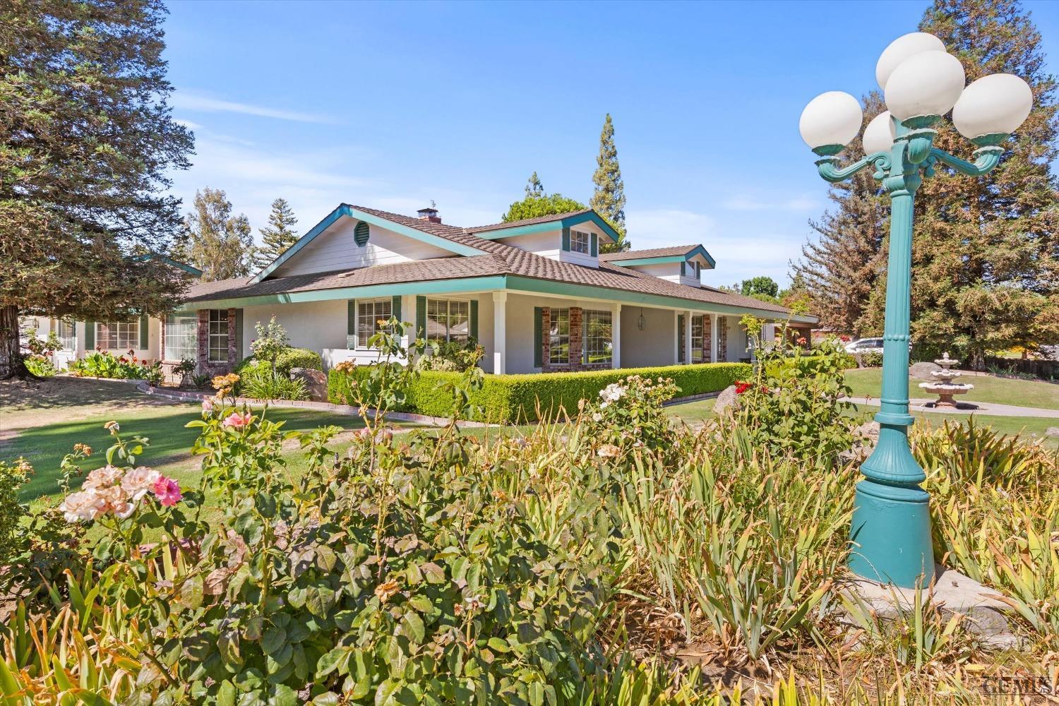Undisclosed Address Bakersfield, CA 93312 - Photo 12 of 46 a front view of a house with a yard and fountain