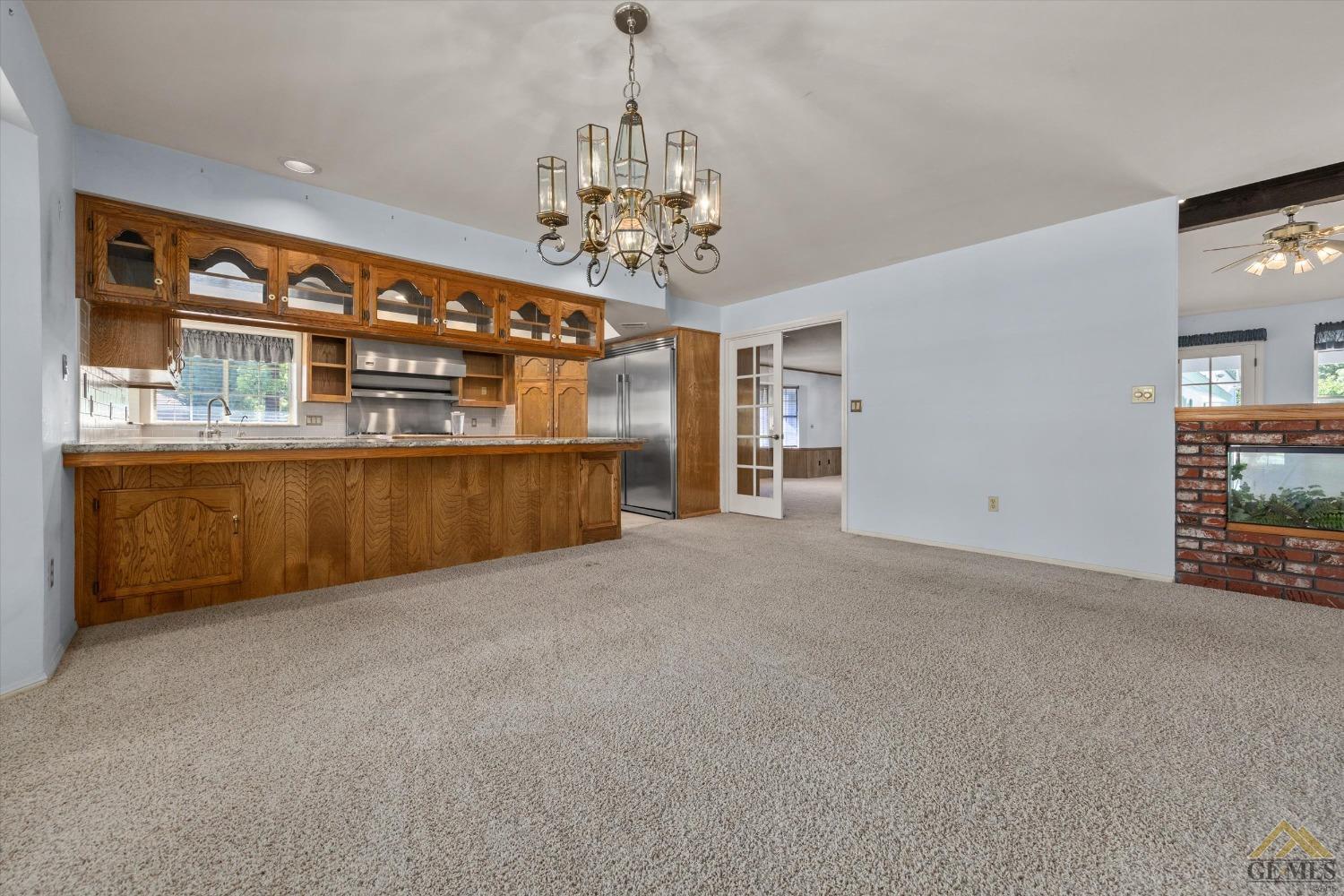 Undisclosed Address Bakersfield, CA 93312 - Photo 18 of 46 a view of a big room with windows and chandelier