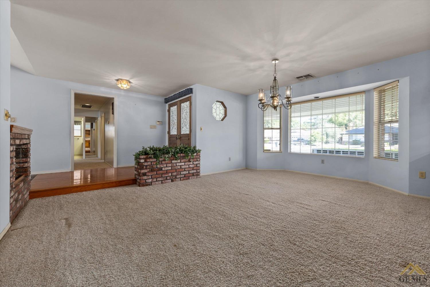 Undisclosed Address Bakersfield, CA 93312 - Photo 19 of 46 an empty room with windows and entrance