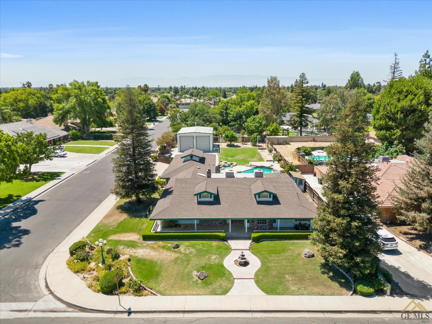 Undisclosed Address Bakersfield, CA 93312 - Photo 2 of 46 a aerial view of a house with swimming pool and a yard