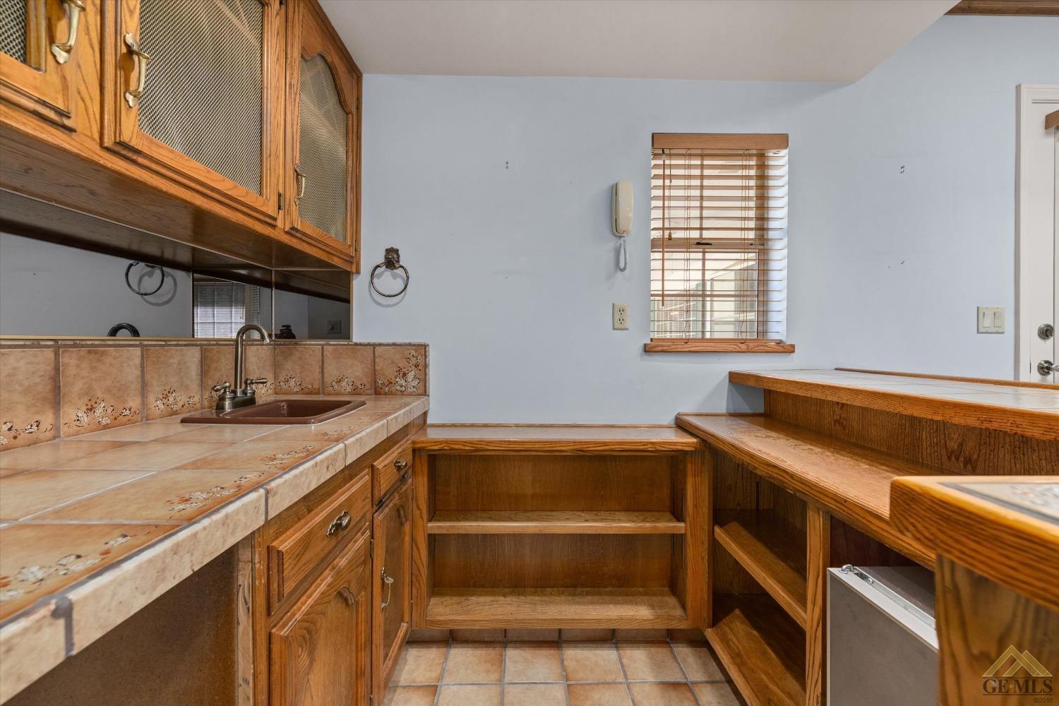 Undisclosed Address Bakersfield, CA 93312 - Photo 22 of 46 a kitchen that has a sink and a stove