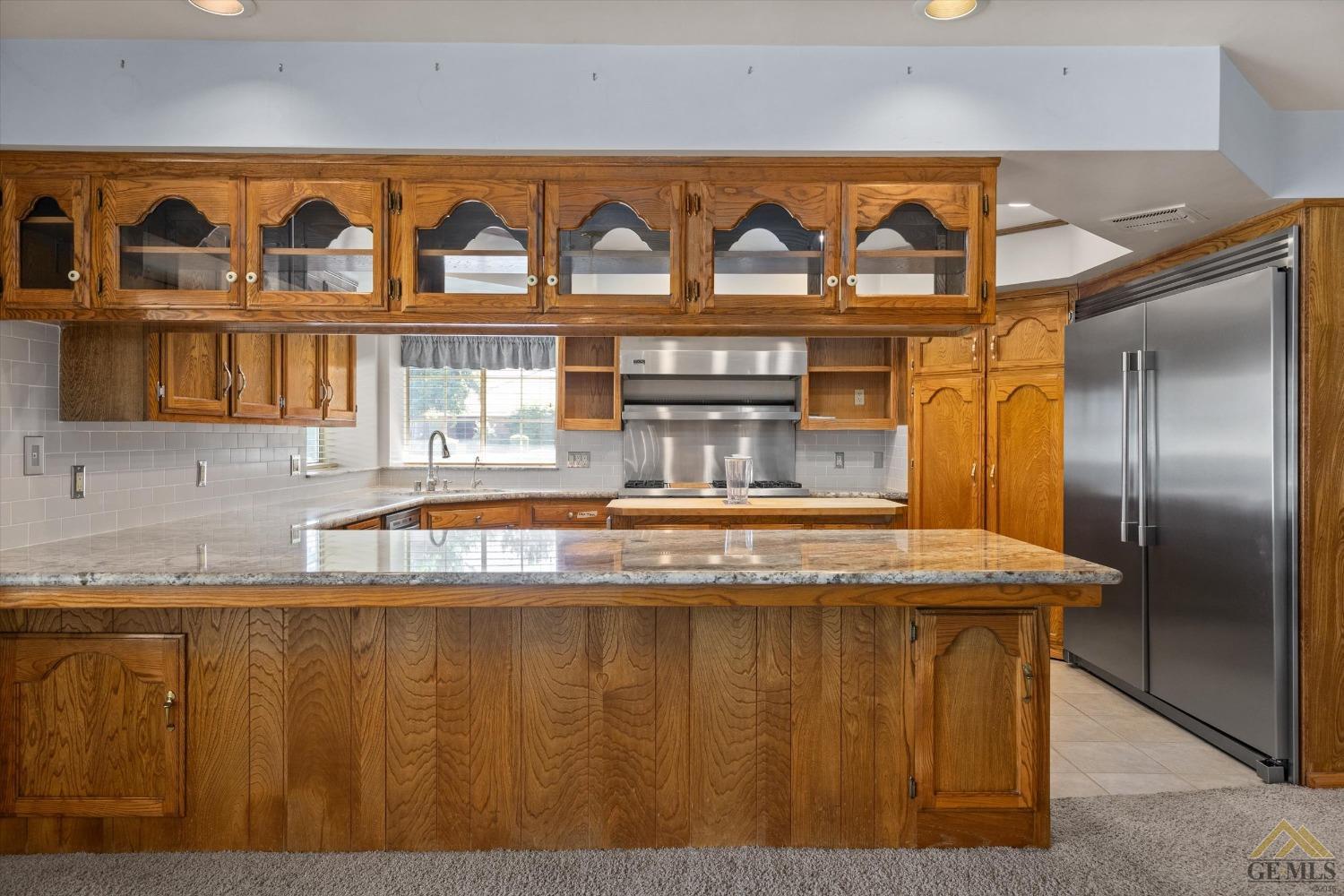 Undisclosed Address Bakersfield, CA 93312 - Photo 24 of 46 a view of a kitchen with stainless steel appliances granite countertop a sink and a refrigerator