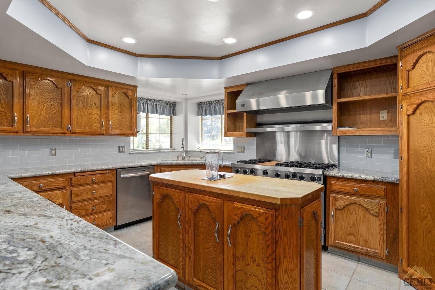 Undisclosed Address Bakersfield, CA 93312 - Photo 26 of 46 a kitchen with stainless steel appliances granite countertop a sink stove and cabinets