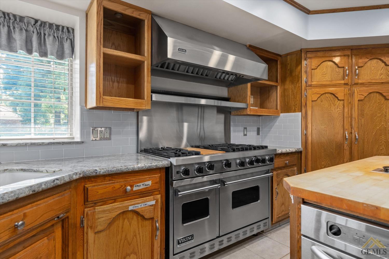 Undisclosed Address Bakersfield, CA 93312 - Photo 27 of 46 a kitchen with stainless steel appliances granite countertop a stove and a sink