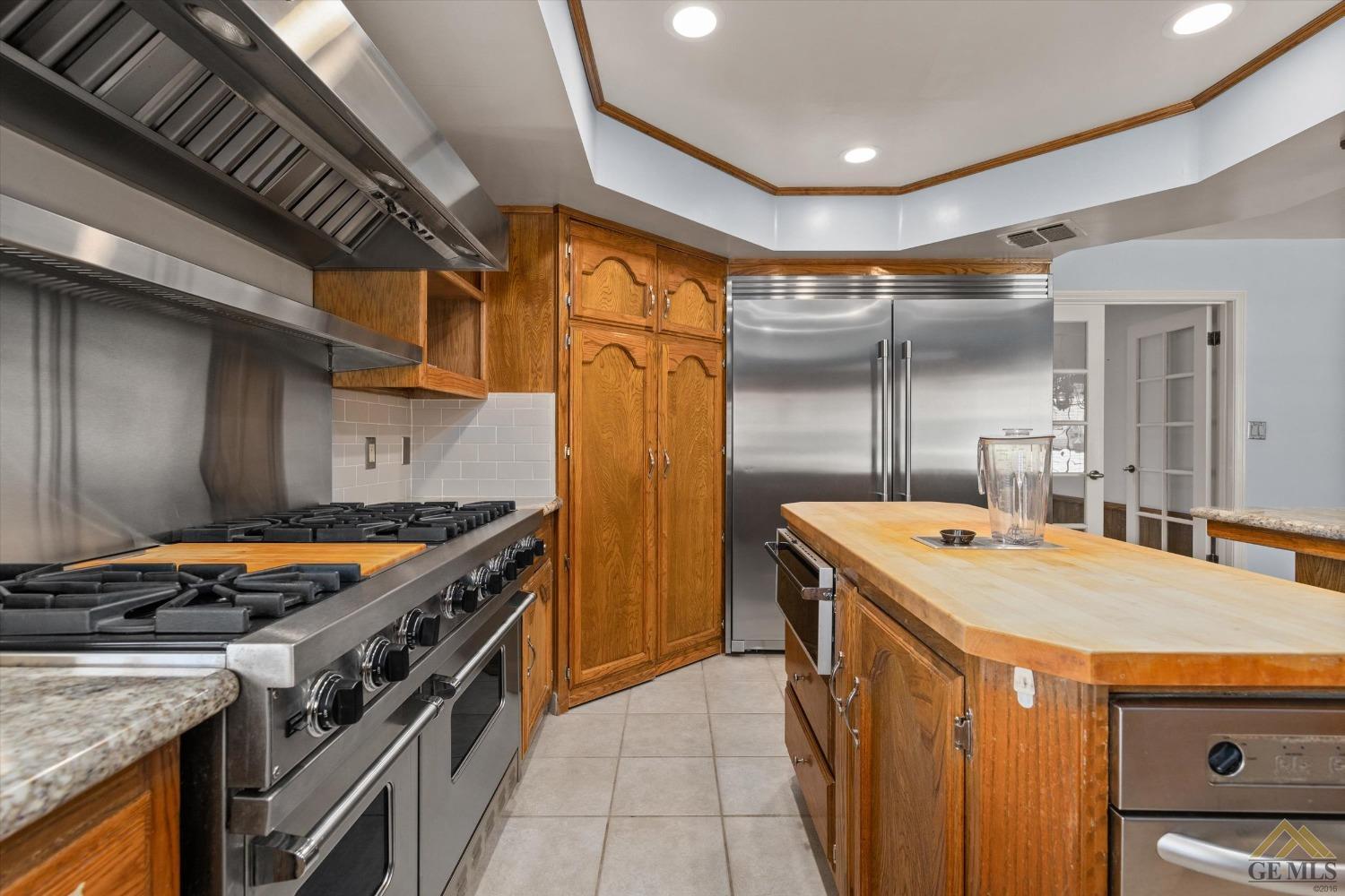 Undisclosed Address Bakersfield, CA 93312 - Photo 28 of 46 a kitchen with stainless steel appliances granite countertop a stove and a refrigerator