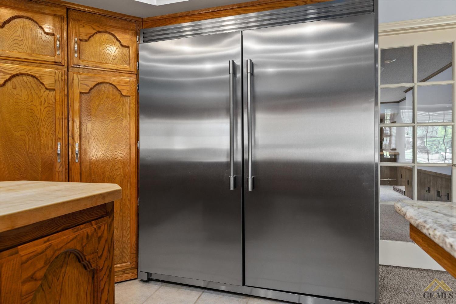 Undisclosed Address Bakersfield, CA 93312 - Photo 29 of 46 a kitchen with metallic refrigerator freezer and a dishwasher