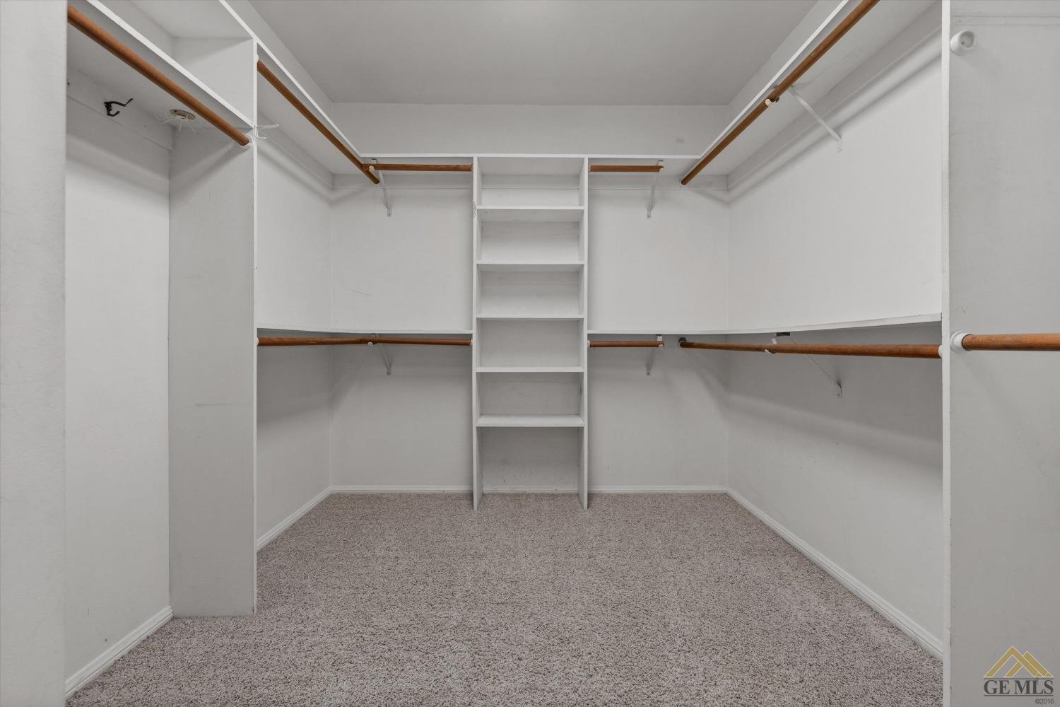 Undisclosed Address Bakersfield, CA 93312 - Photo 35 of 46 a view of walk in closet with empty racks