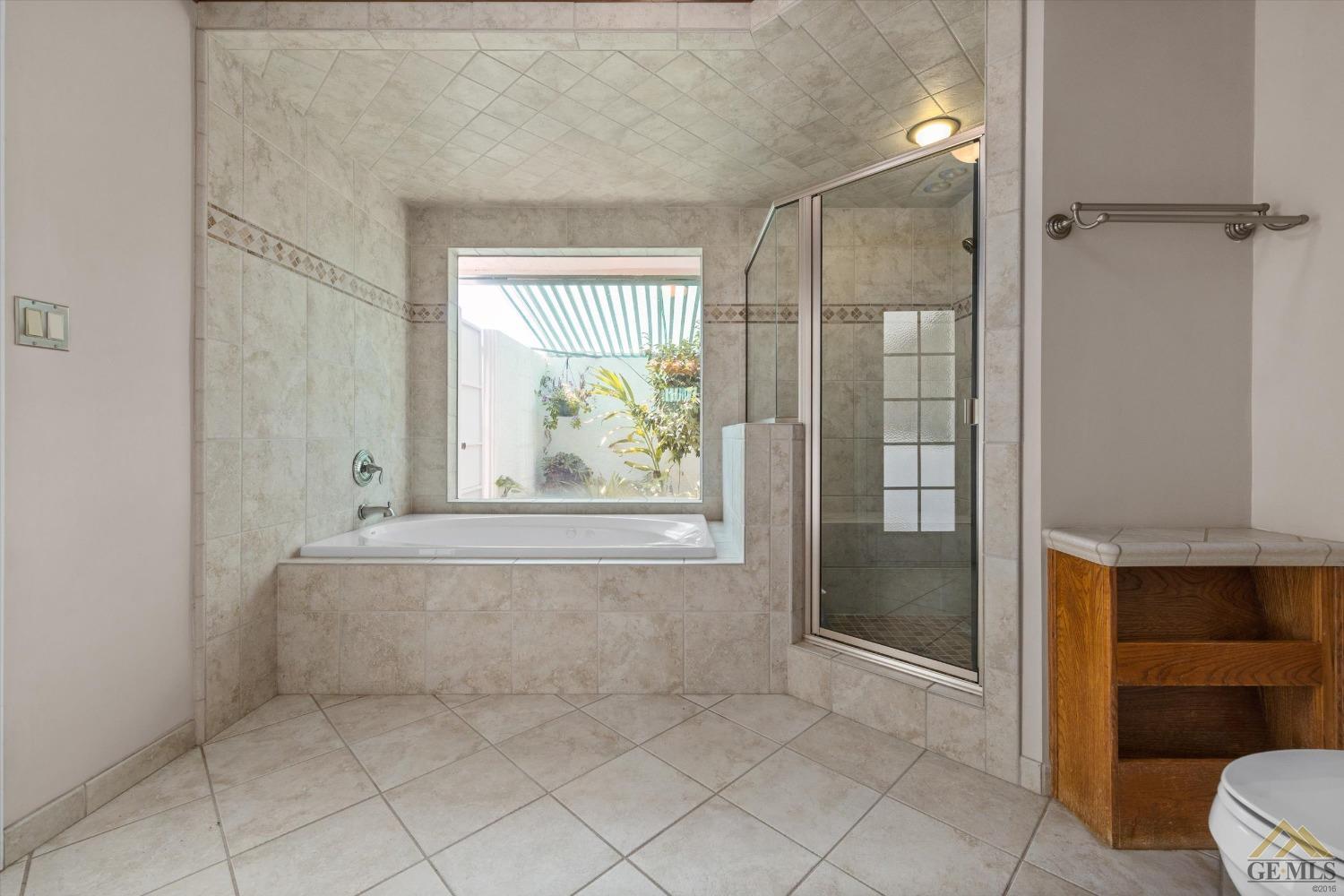 Undisclosed Address Bakersfield, CA 93312 - Photo 37 of 46 a bathroom with a tub and shower