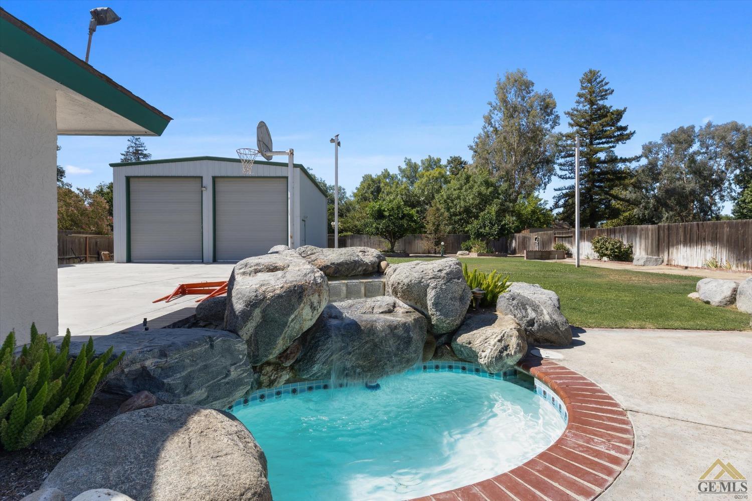 Undisclosed Address Bakersfield, CA 93312 - Photo 44 of 46 a backyard of a house with yard and outdoor seating