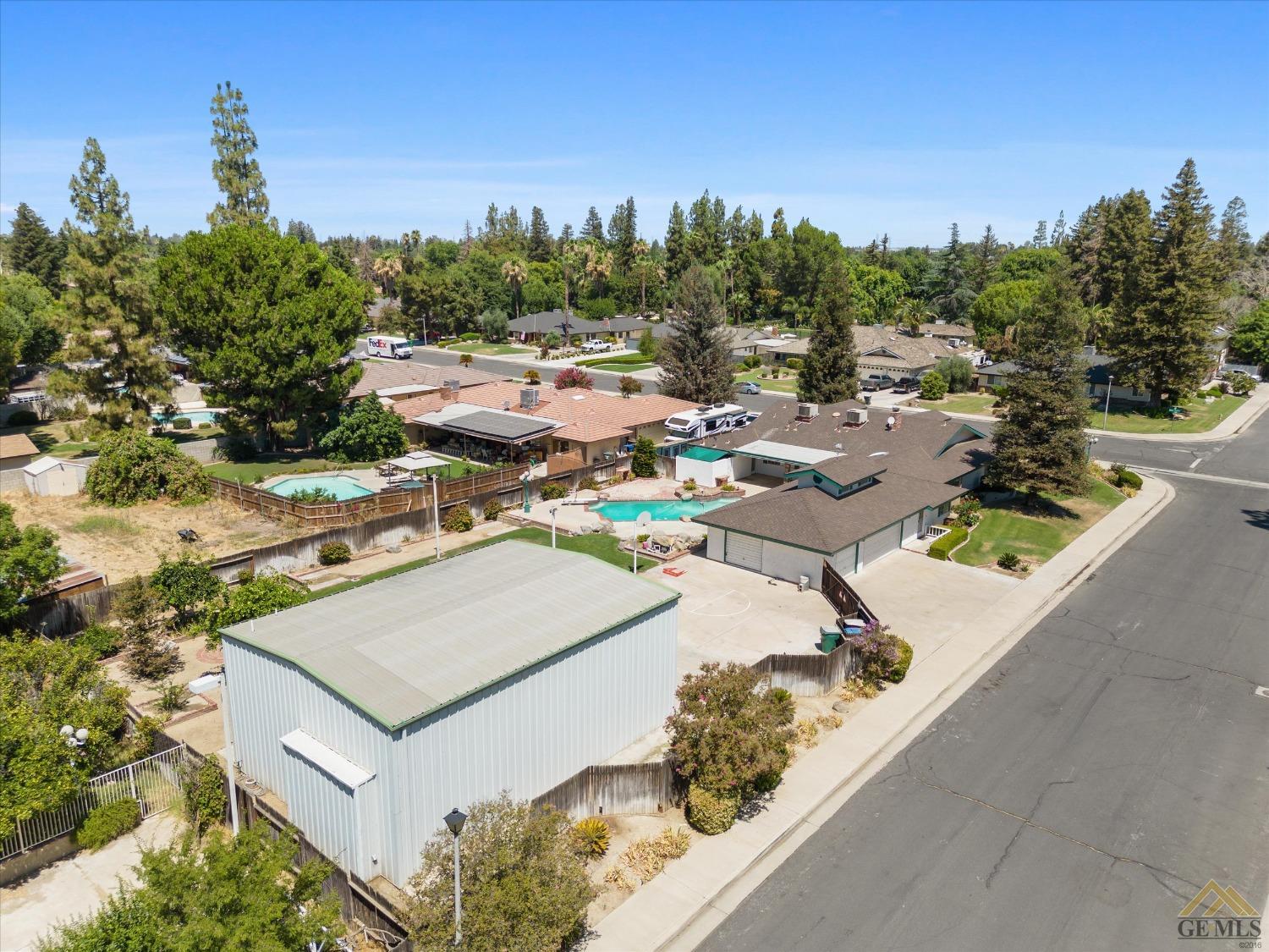 Undisclosed Address Bakersfield, CA 93312 - Photo 6 of 46 an aerial view of a house with a yard and lake view