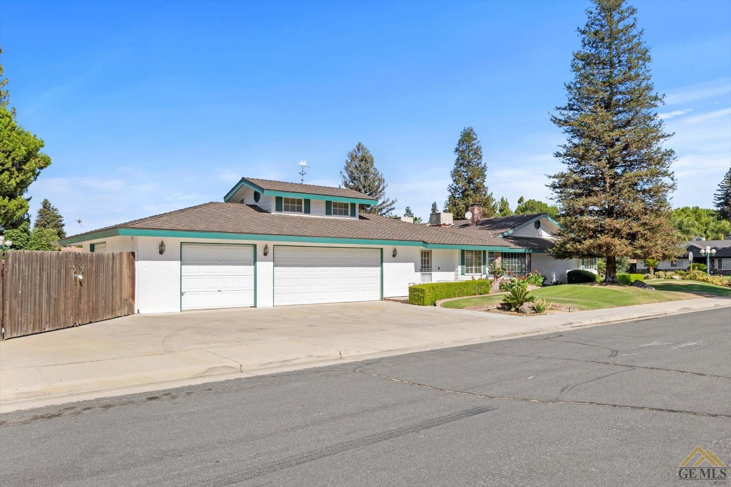 Undisclosed Address Bakersfield, CA 93312 - Photo 8 of 46 a view of a house with a yard and palm trees