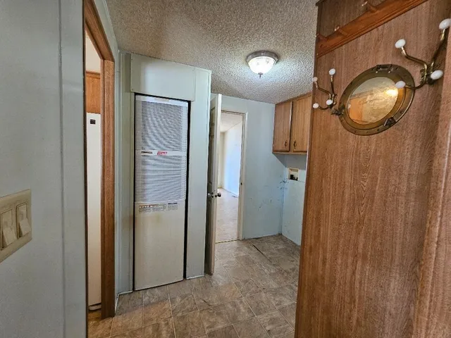 a kitchen with a sink a stove top oven and a refrigerator